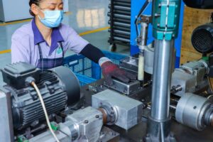 ISO 9001-certified automated tapping machine threading Contuo standing desk parts at ±0.005mm tolerance, 45-second cycle time per unit, operator-assisted CNC control under ISO 13849 safety standards